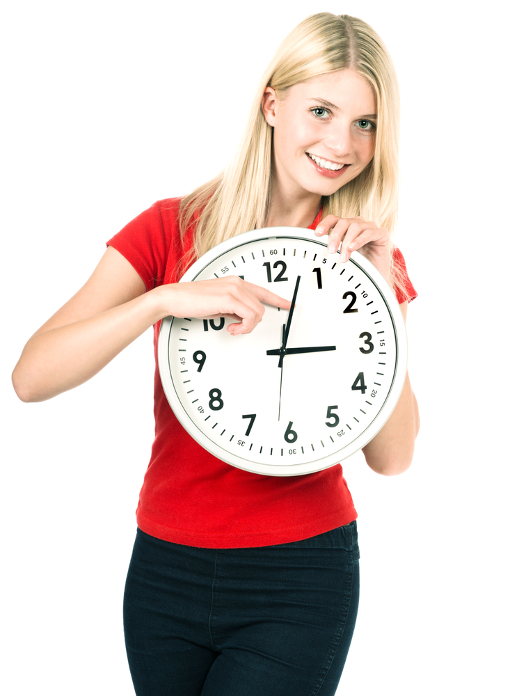 young woman holding a clock. time management concept. summer time (Daylight Saving Time)